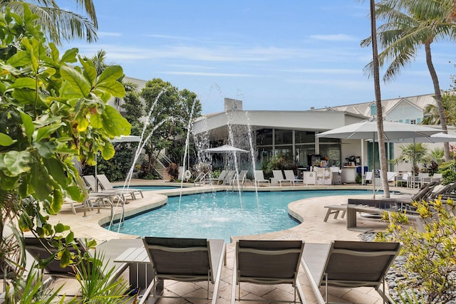 view of pool with pool water feature and a patio