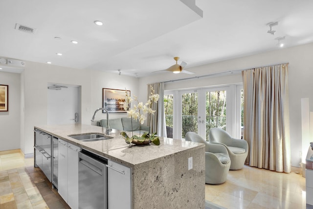 kitchen with dishwasher, sink, white cabinets, a center island, and french doors