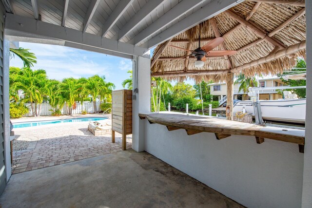 view of patio / terrace featuring ceiling fan and a fenced in pool