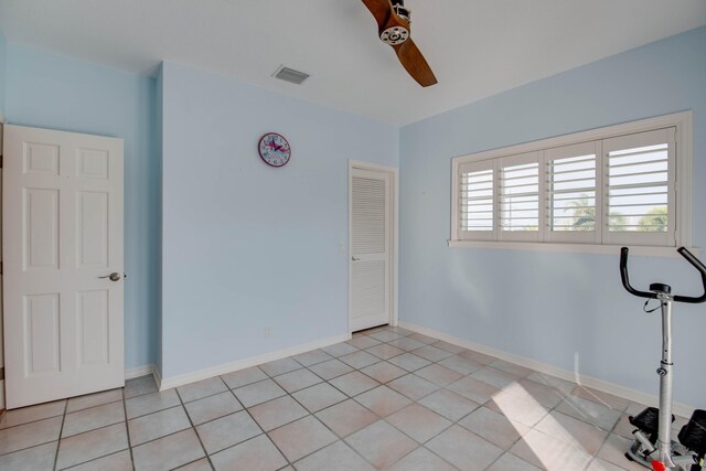 interior space with light tile patterned flooring and ceiling fan