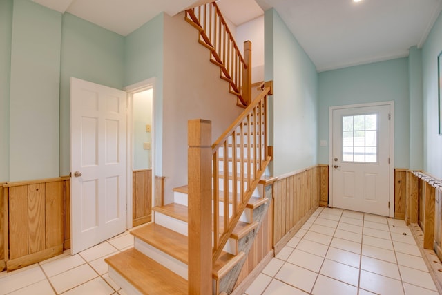 tiled entrance foyer with wood walls