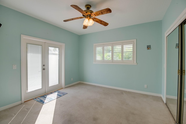 doorway to outside featuring french doors, ceiling fan, and light carpet