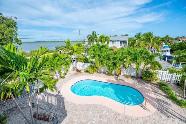 view of pool featuring a water view and a patio