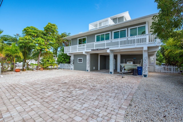 raised beach house with a carport and a balcony