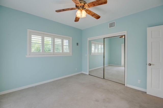 unfurnished bedroom with light colored carpet, a closet, and ceiling fan