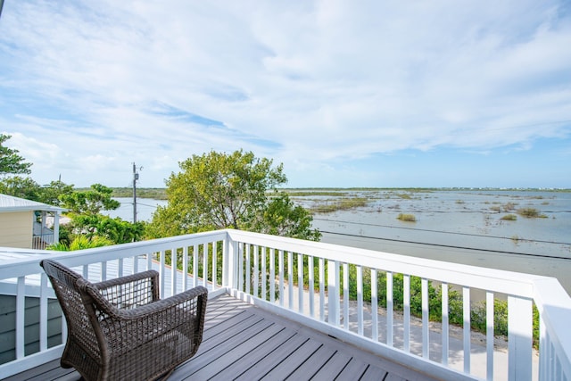 wooden deck featuring a water view