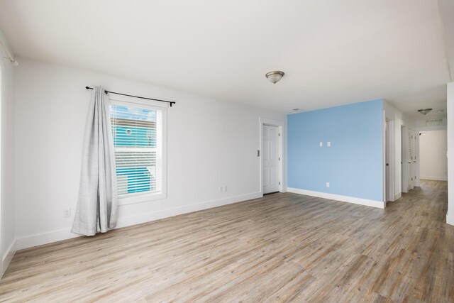 unfurnished room with light wood-type flooring