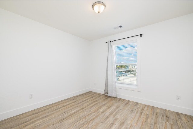 spare room with light hardwood / wood-style floors