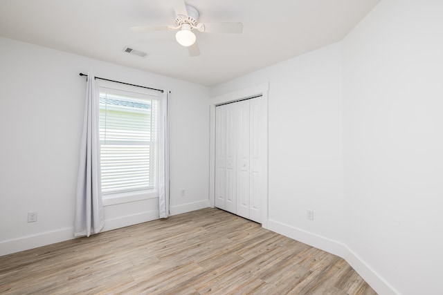 unfurnished bedroom with a closet, ceiling fan, and light wood-type flooring