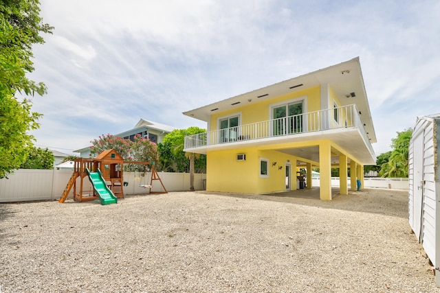 back of property with a playground