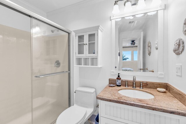 bathroom featuring crown molding, vanity, toilet, and an enclosed shower