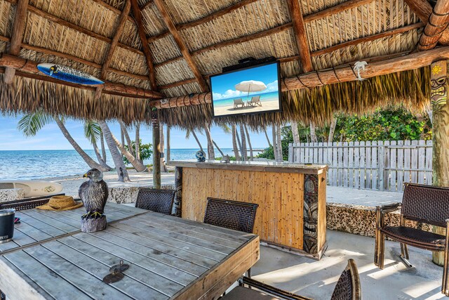 view of patio / terrace with a gazebo, an outdoor bar, and a water view