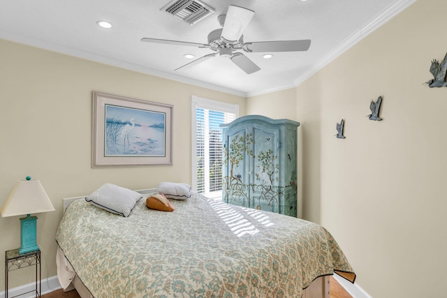 bedroom featuring ornamental molding, wood-type flooring, and ceiling fan