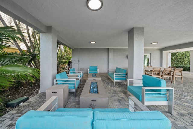 view of patio featuring an outdoor living space with a fire pit