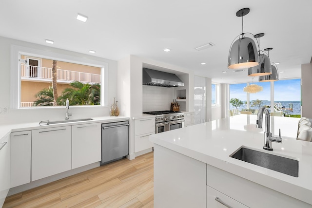 108 N Bounty Ln, Key Largo, FL 33037 - kitchen with a sink, white cabinetry, wall chimney exhaust hood, and stainless steel appliances