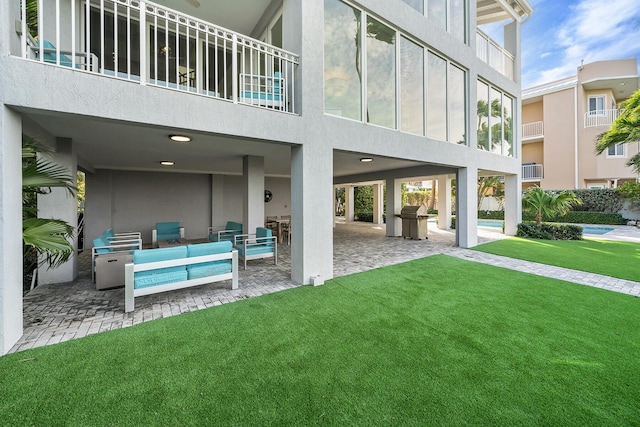 exterior space featuring a yard, an outdoor hangout area, a patio, and a balcony