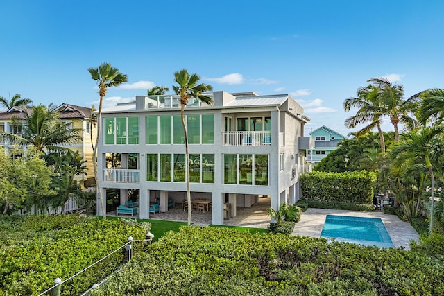108 N Bounty Ln, Key Largo, FL 33037 - rear view of house featuring a balcony, fence, a patio, and an outdoor pool