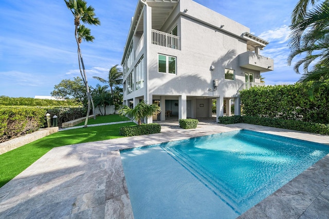 view of pool featuring a patio and a lawn