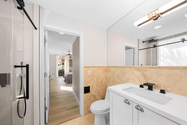 108 N Bounty Ln, Key Largo, FL 33037 - bathroom featuring vanity, toilet, tile walls, and a stall shower