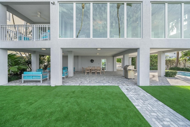 108 N Bounty Ln, Key Largo, FL 33037 - back of house featuring a lawn, stucco siding, and a patio area
