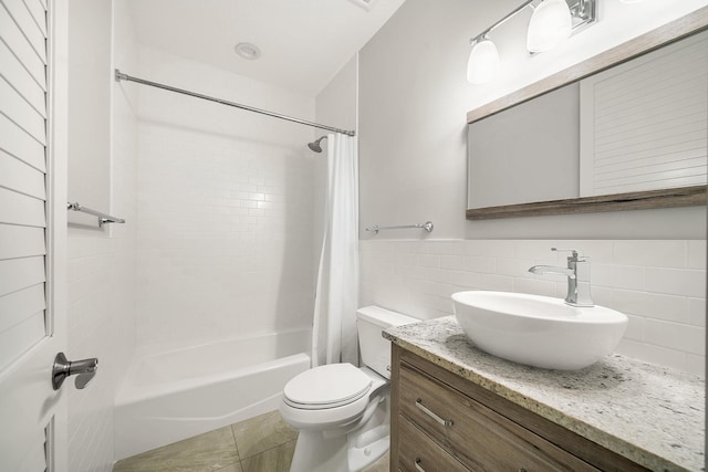 full bathroom featuring tile patterned floors, toilet, shower / tub combo, tile walls, and vanity