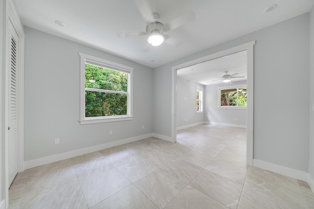 unfurnished room with ceiling fan