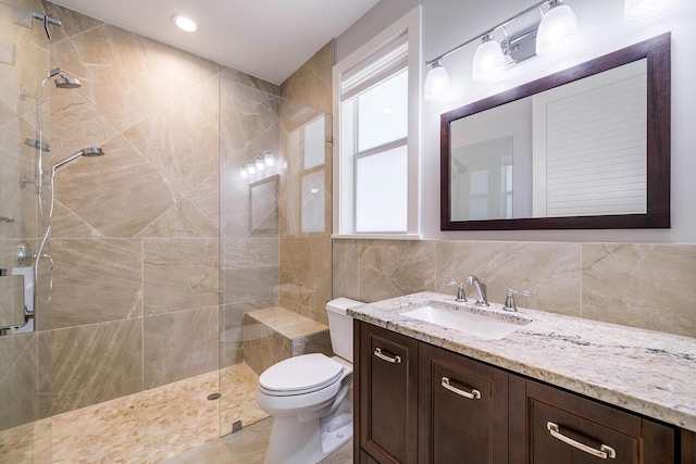 bathroom with vanity, toilet, and a shower with door