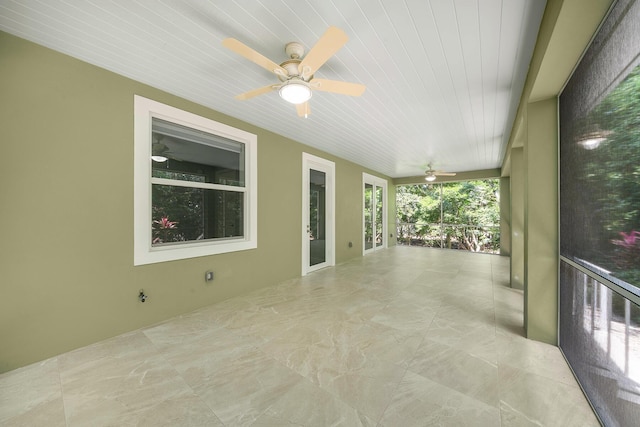 unfurnished sunroom with ceiling fan and wooden ceiling