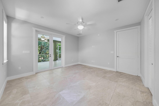 empty room with french doors and ceiling fan