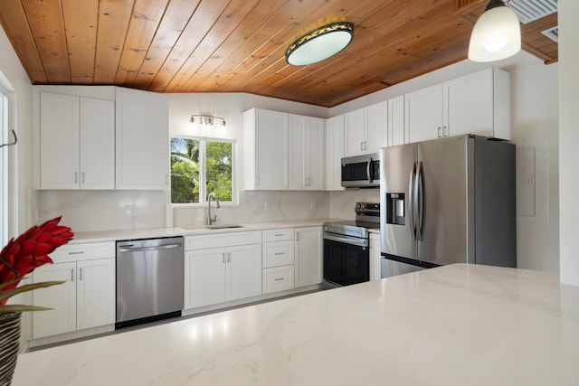 415 Big Pine Rd, Key Largo, FL 33037 - kitchen featuring stainless steel appliances, wood ceiling, white cabinets, light stone countertops, and lofted ceiling