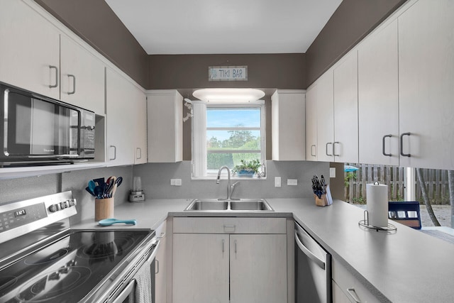 1103 S Indies Dr, Duck, FL 33050 - kitchen with stainless steel appliances, a sink, light countertops, and white cabinetry