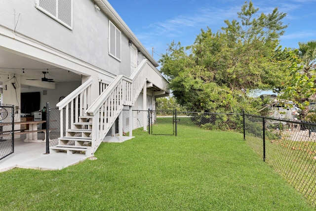 view of yard featuring ceiling fan and a patio area