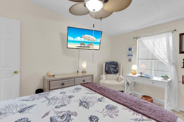 bedroom featuring lofted ceiling, ceiling fan, and a textured ceiling