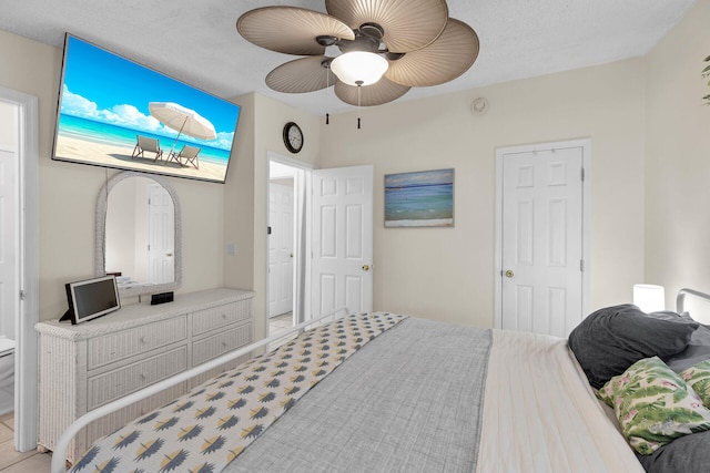 bedroom with a textured ceiling and ceiling fan