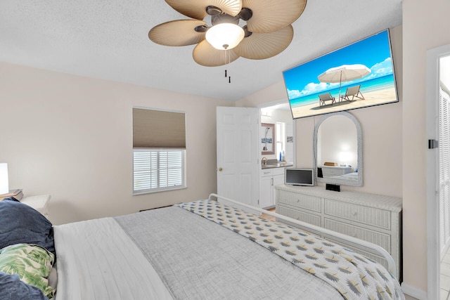 bedroom featuring vaulted ceiling, sink, and ceiling fan