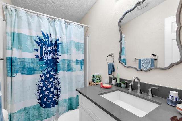 bathroom with vanity, a shower with shower curtain, a textured ceiling, and toilet