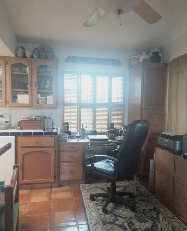 office space with light tile patterned floors and a ceiling fan