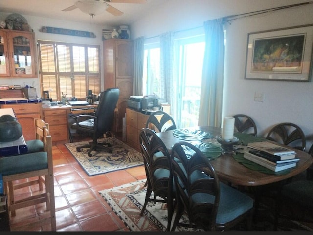 home office with a wealth of natural light, ceiling fan, and light tile patterned flooring