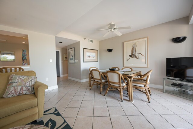 tiled dining space with ceiling fan