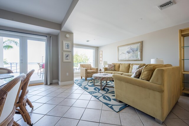 living room featuring light tile patterned floors and french doors