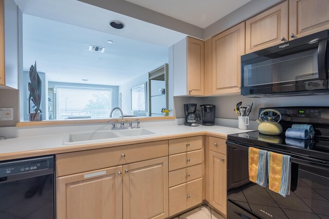 kitchen with sink, light brown cabinets, and black appliances