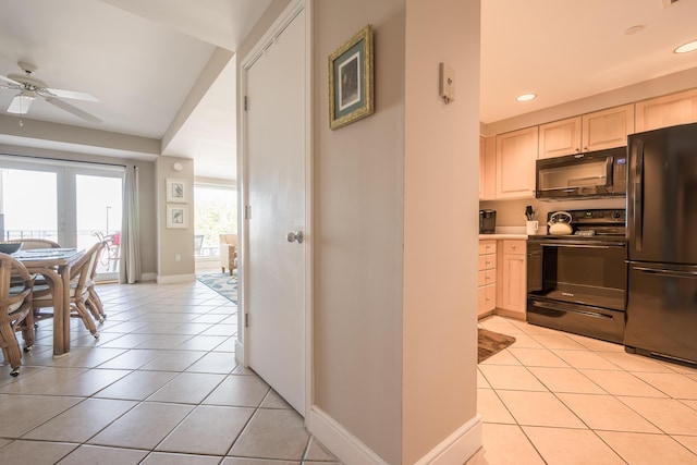 kitchen featuring ceiling fan, light tile patterned floors, and black appliances