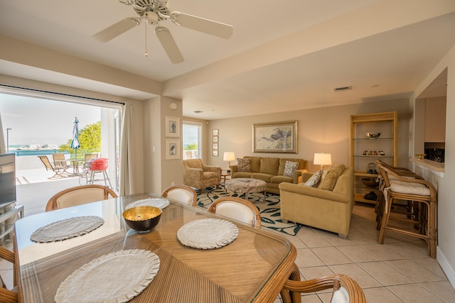 tiled dining area with ceiling fan