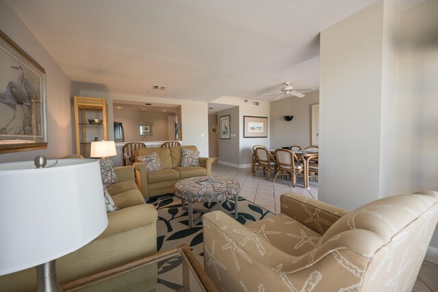 living room featuring light tile patterned floors and ceiling fan