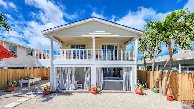 rear view of property featuring a patio and a balcony