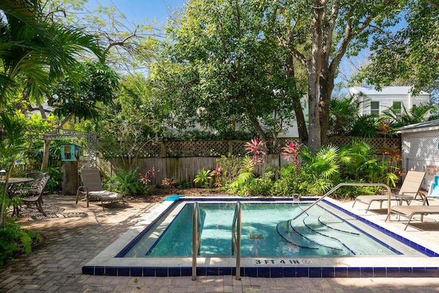 view of swimming pool with a patio, a swimming pool, and a fenced backyard