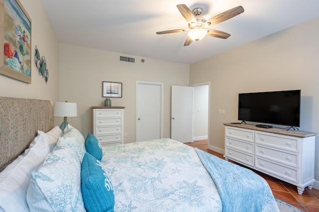 115 Front St Unit 102, Key West, FL 33040 - tiled bedroom featuring a ceiling fan and baseboards