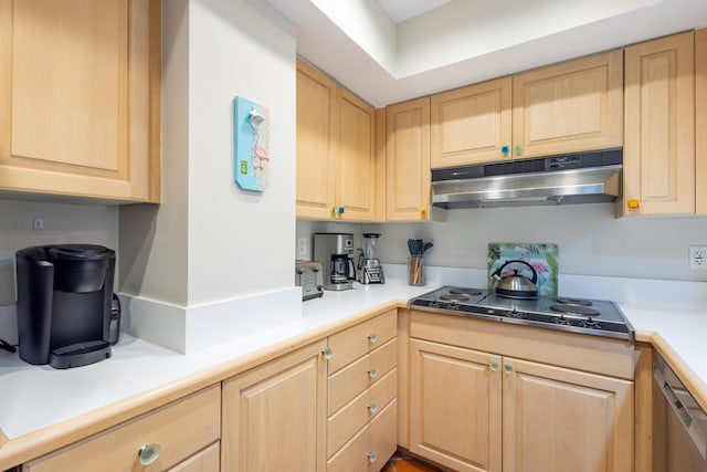 115 Front St Unit 102, Key West, FL 33040 - kitchen with under cabinet range hood, light brown cabinets, electric cooktop, and light countertops