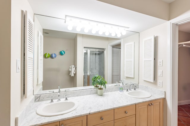 115 Front St Unit 102, Key West, FL 33040 - bathroom featuring a closet, double vanity, tile patterned flooring, and a stall shower