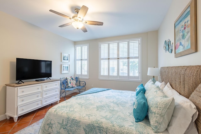 115 Front St Unit 102, Key West, FL 33040 - bedroom with multiple windows, dark tile patterned flooring, and ceiling fan